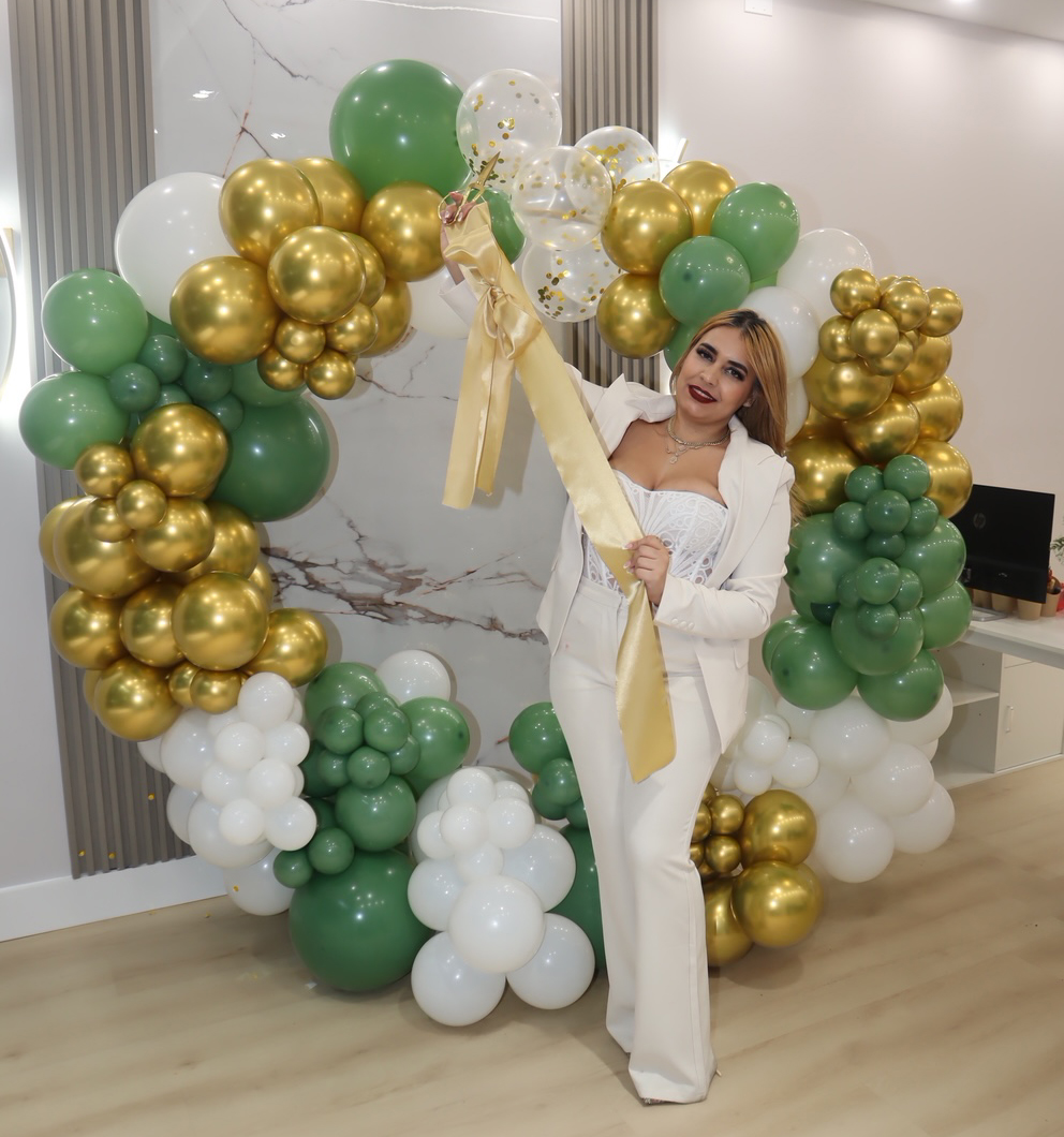 Agent at office in front of balloon wall